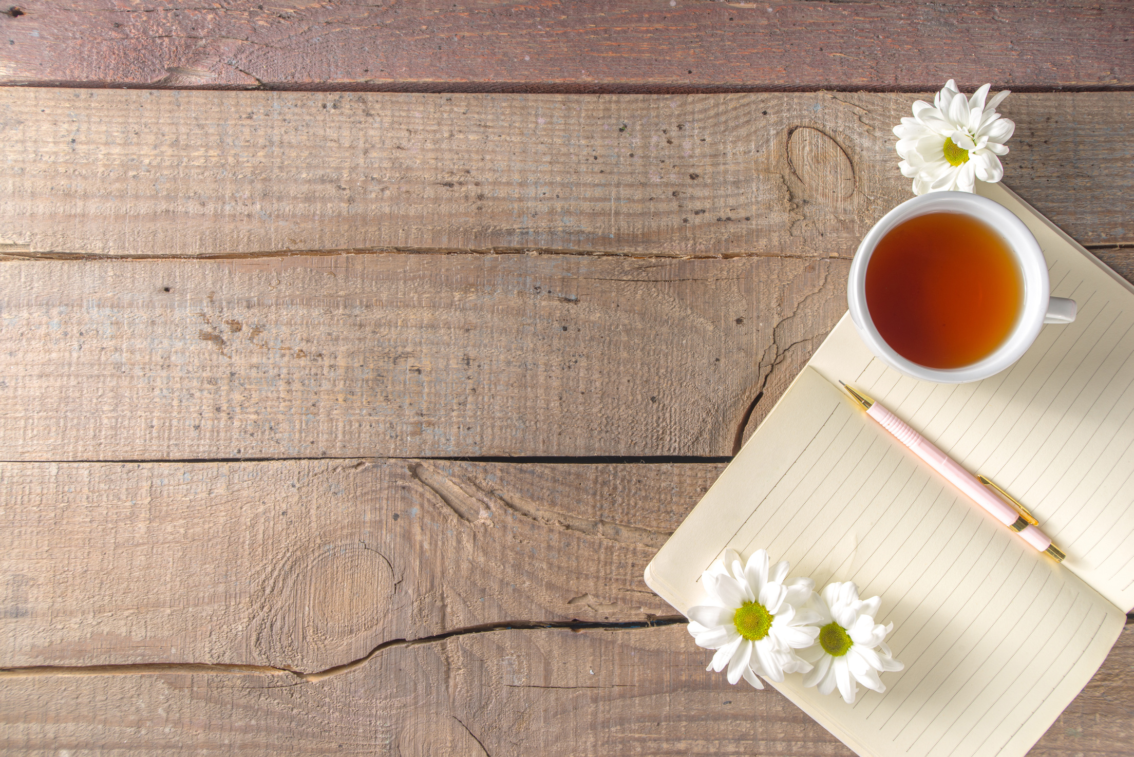 Chamomile Flowers, Notebook and Tea Background